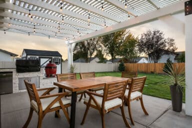 white house with white pergola and red BBQ grill in Boise, Idaho.