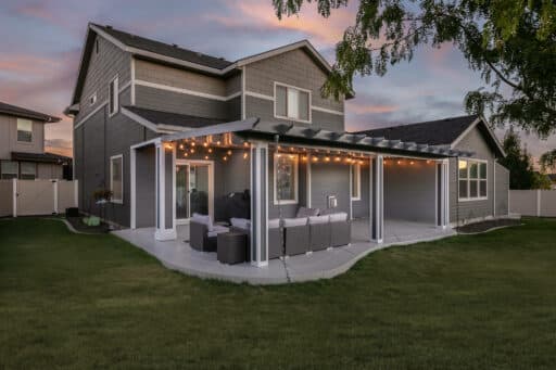 grey house with grey and white patio cover with white trim