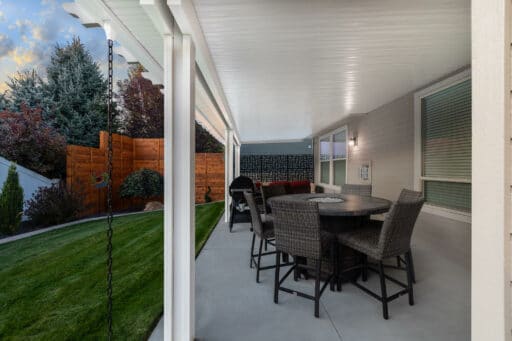 white patio cover with red and tan patio furniture