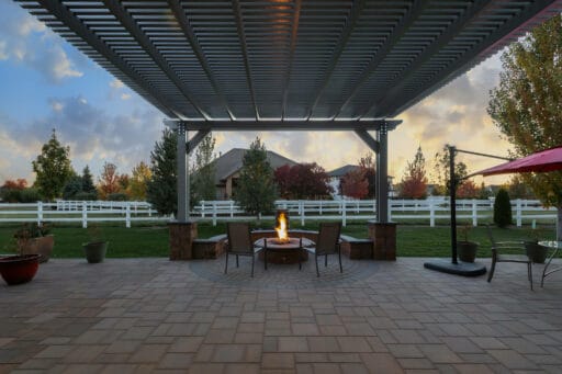 grey pergola and tan patio cover covering a fire pit