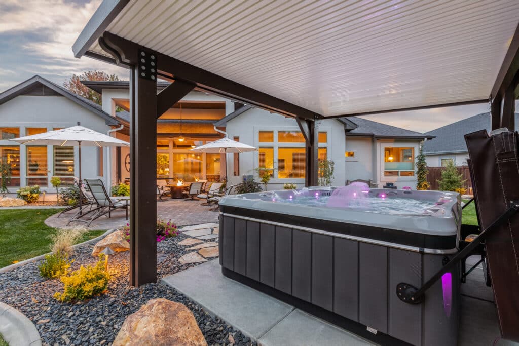 brown and tan detached patio cover over a colorful hot tub in Nampa, Idaho.